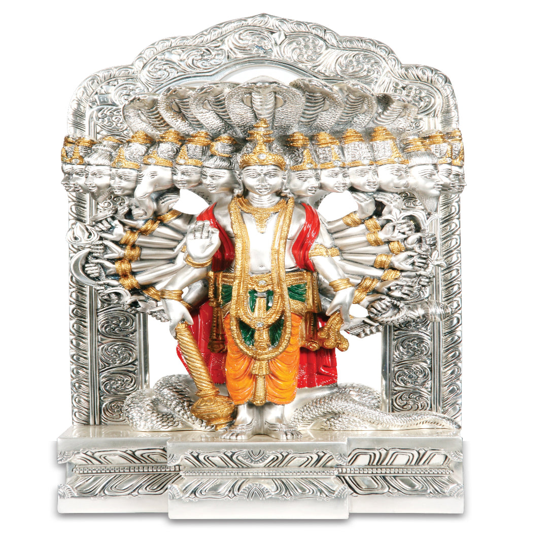 Decorative statue of a deity with intricate silver and gold detailing on a white background