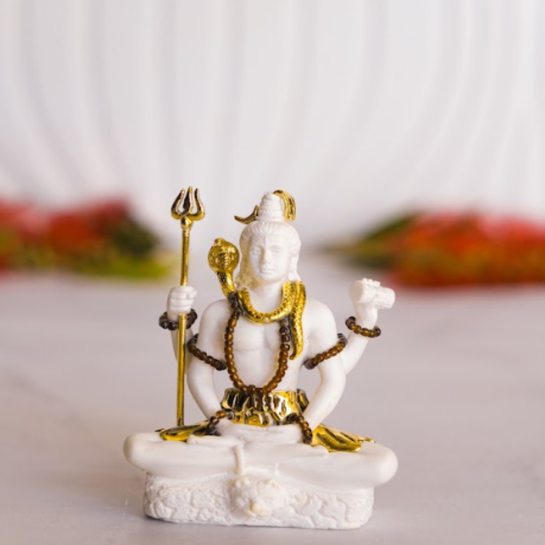 White and gold statue of a deity on a white background