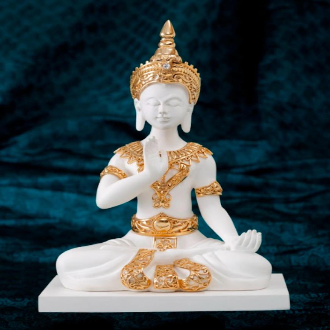 White and gold statue of a seated figure on a dark blue background